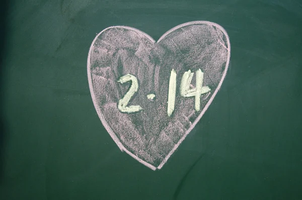 Love sign drawn with chalk on blackboard — Stock Photo, Image