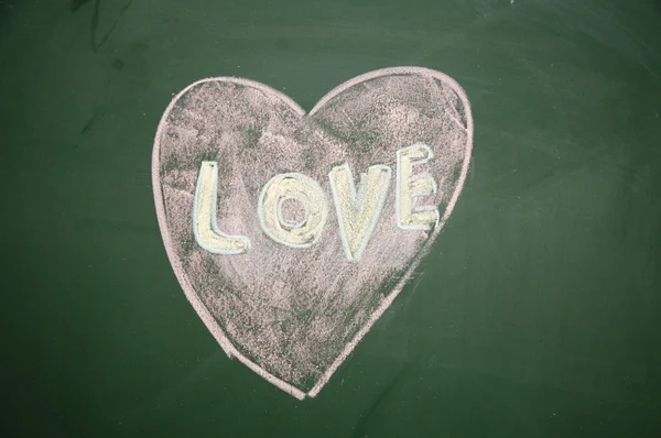 Love sign drawn with chalk on blackboard — Stock Photo, Image