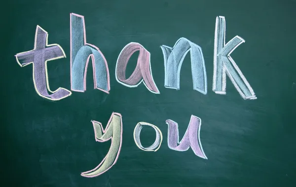 Thank you title written with chalk on board — стоковое фото