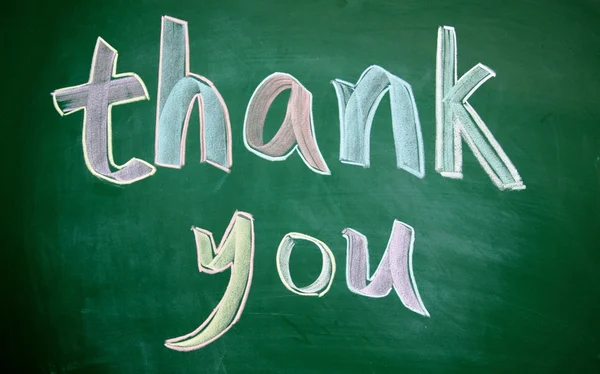 Thank you title written with chalk on board — стоковое фото