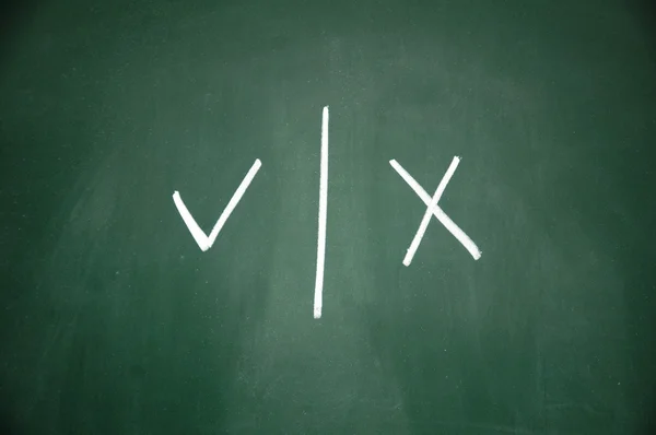 Right and wrong symbol written with chalk on blackboard — Stock Photo, Image