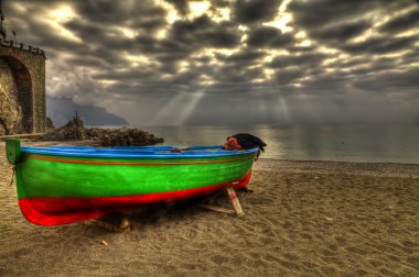 Atrani boat in beach during a strom HDR clipart