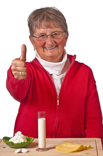 Pensioner with dairy products — Stock Photo, Image