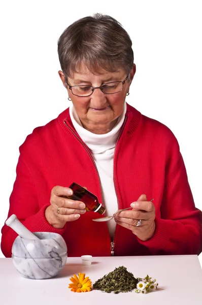 Pensioner taking herbal drops — Stock Photo, Image