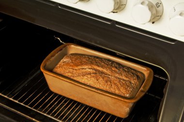 Whole grain bread in an oven clipart