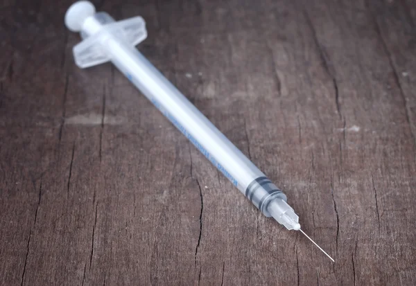 Syringe on wooden table — Stock Photo, Image