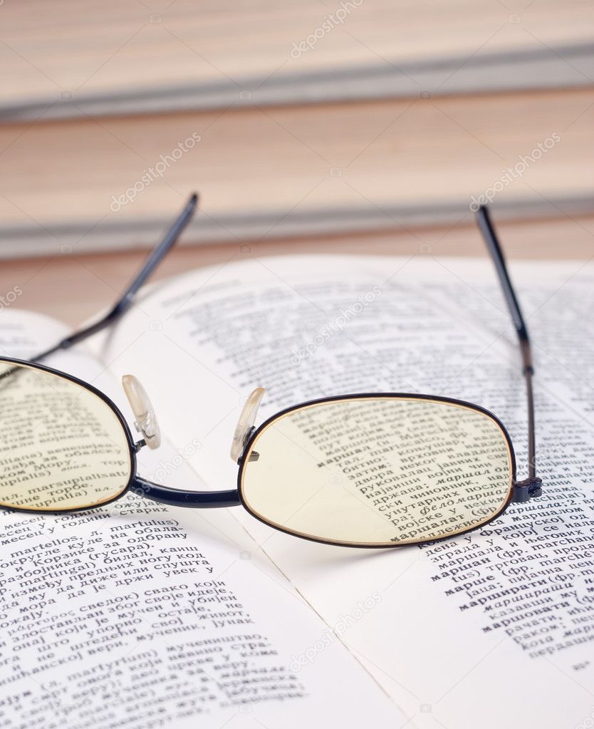 Glasses on the open book