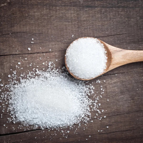 Sugar in a wooden spoon — Stock Photo, Image