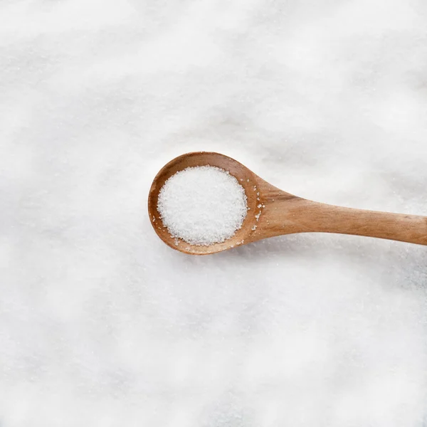 Salt in a wooden spoon — Stock Photo, Image