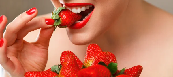Woman eating strawberry — Stock Photo, Image
