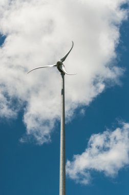 Spinning Windmill with Blue Sky and Clouds clipart