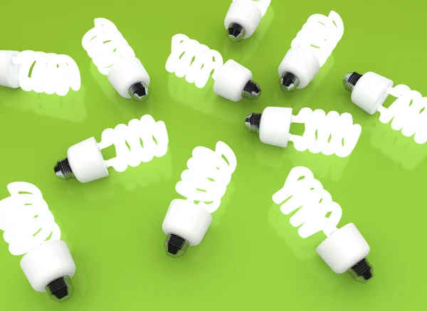 Energieeffiziente Glühbirnen auf grünem Hintergrund — Stockfoto
