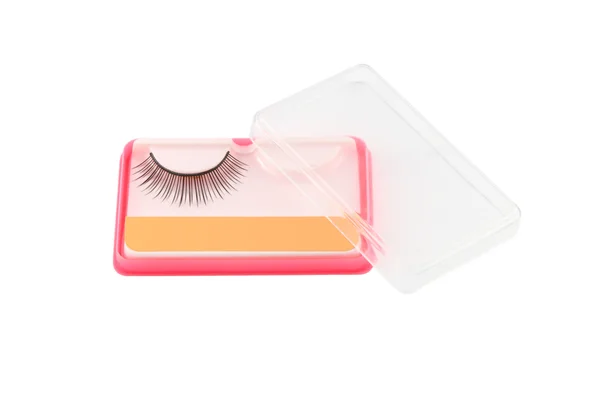 Ψευδείς eyelashe στο ροζ πακέτο και διαφανής κάλυψη σε λευκό φόντο. — Φωτογραφία Αρχείου