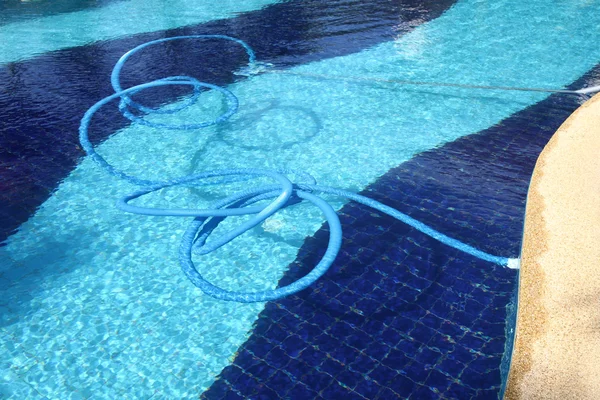 Pool cleaning pipe floating. Stock Picture