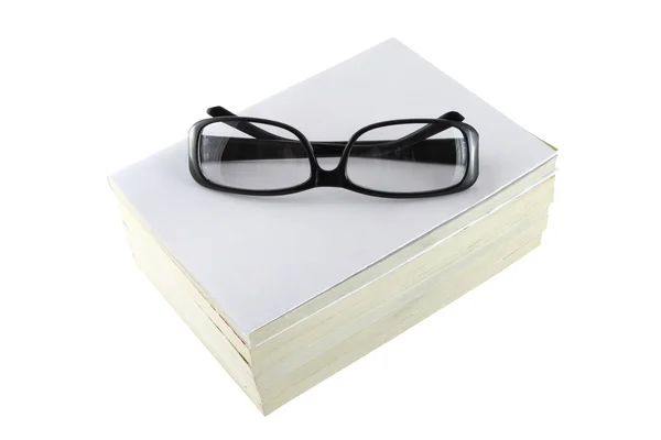 Montura de gafas de ojo negro en libro blanco . — Foto de Stock