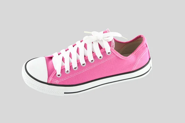 Pink sport shoe on gray background.