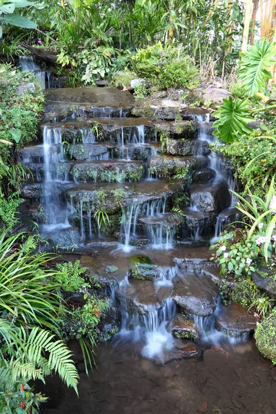 Small waterfall of tropical resort. — Stock Photo, Image