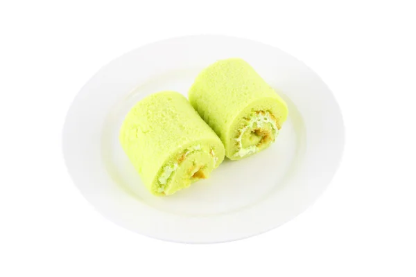 Green sweet roll cake on dish. — Stock Photo, Image