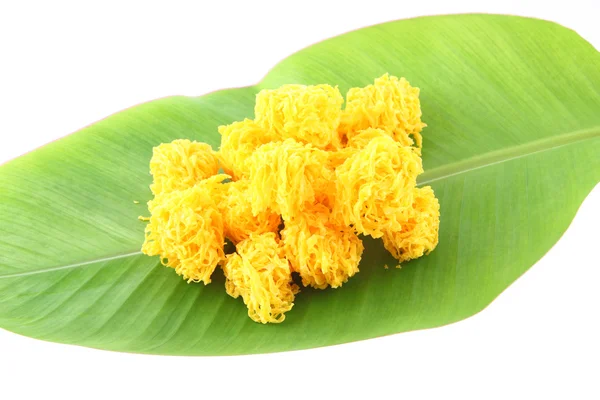 stock image Near sweetmeat made of egg yolk and sugar on banana leaf.