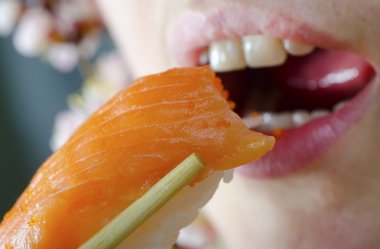 Woman eating sushi clipart