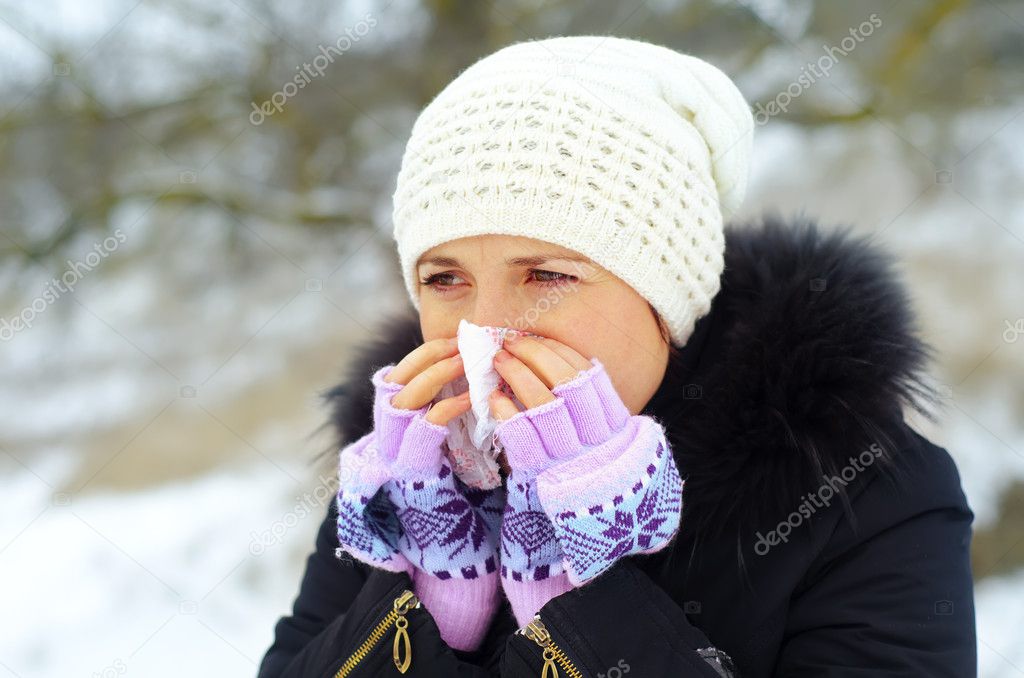 Young woman blow one's nose