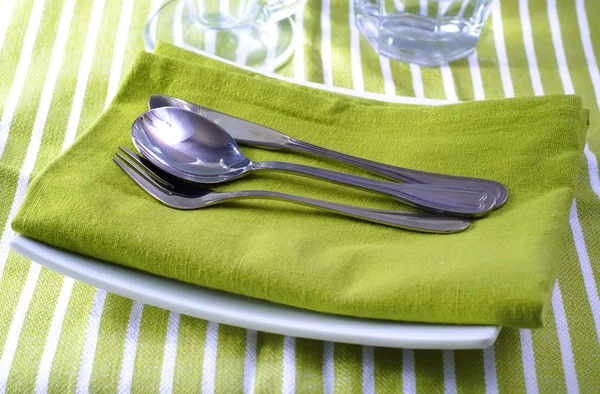 stock image Place setting on green napkin and white plates