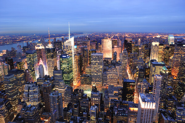 New York City Manhattan Times Square night city skyline aerial view with urban skyscraper illuminated.