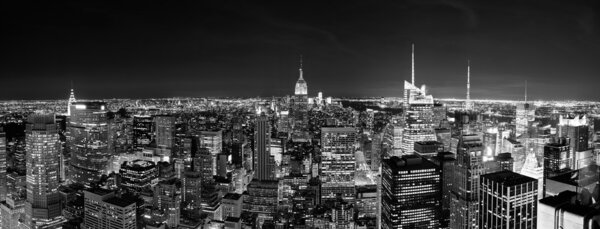 New York City Manhattan skyline at night panorama black and white with urban skyscrapers.