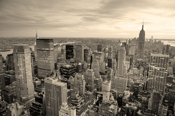New York City skyline black and white with urban skyscrapers at sunset.