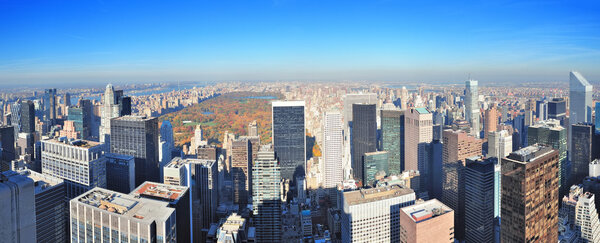 New York City skyscrapers in midtown Manhattan aerial panorama view in the day with Central Park and colorful foliage in Autumn.
