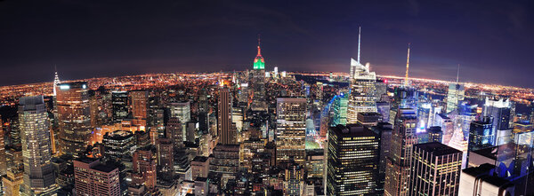 New York City skyline aerial panorama view at night with Empire State Building, Times Square and skyscrapers of midtown Manhattan.