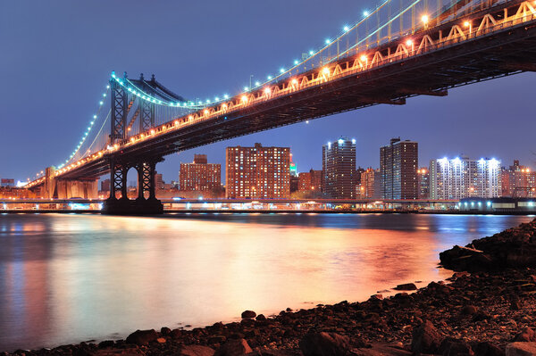 New York City Manhattan Bridge closeup with downtown skyline over East River.