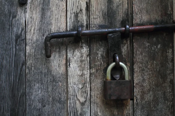 stock image Vintage wooden door with a padlock