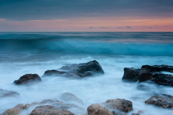 Belle plage de mer rocheuse au coucher du soleil — Photo