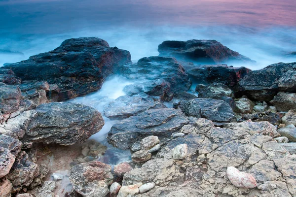 stock image Beautiful rocky sea beach at the sunset