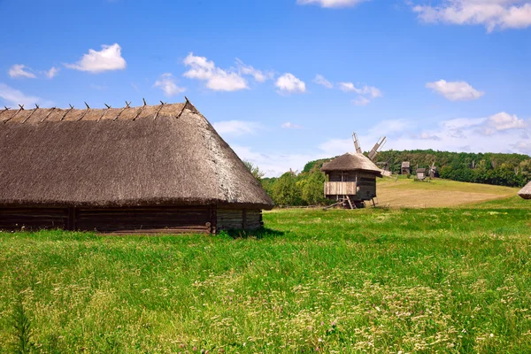 stock image Beautiful village landscape with wooden houses and windmills