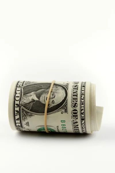 Rolo de notas de dólar em fundo simples — Fotografia de Stock