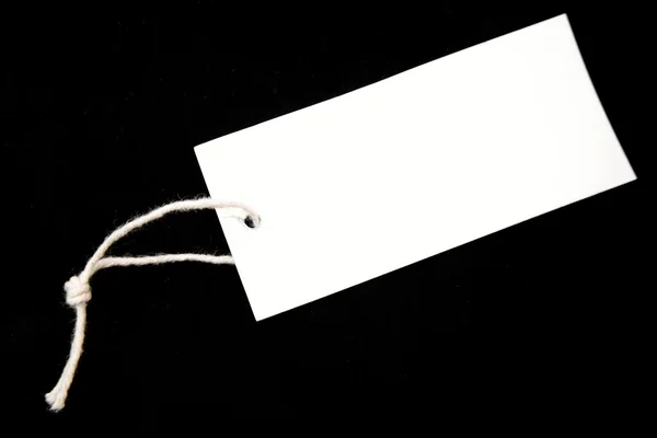 Tag and string on black background — Stock Photo, Image