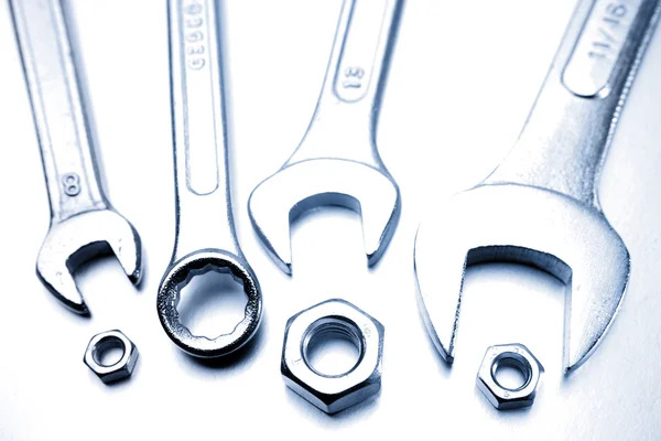 stock image Four spanners and nuts closeup