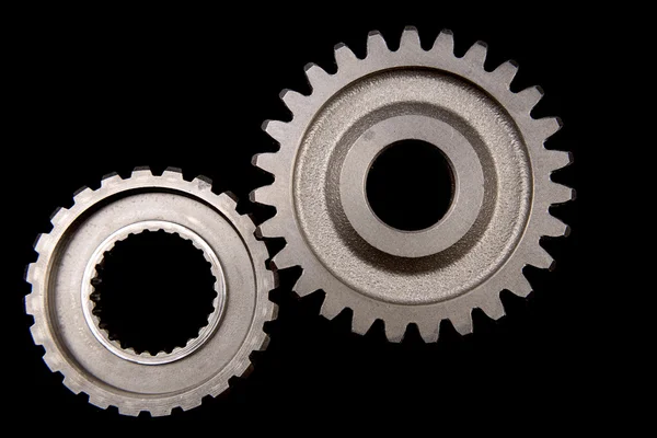 Closeup of two cogs on black — Stock Photo, Image
