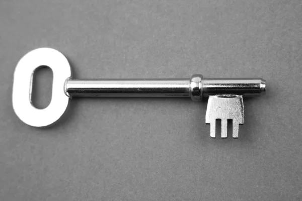 Closeup of single key on blue — Stock Photo, Image