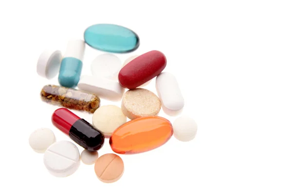 Assorted pills on plain background — Stockfoto