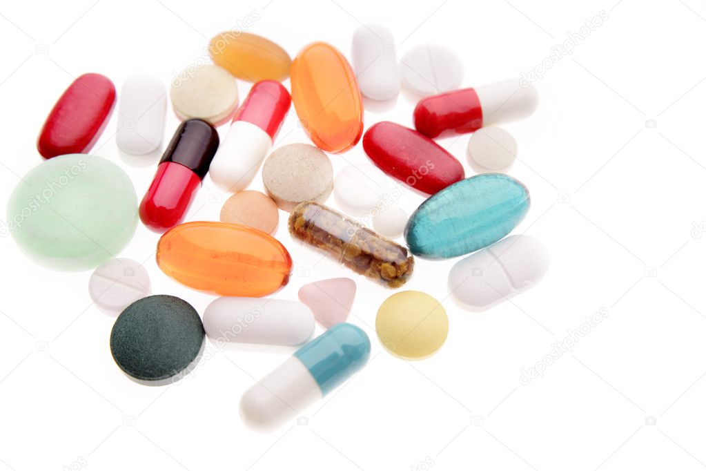 Closeup of assorted pills on plain background