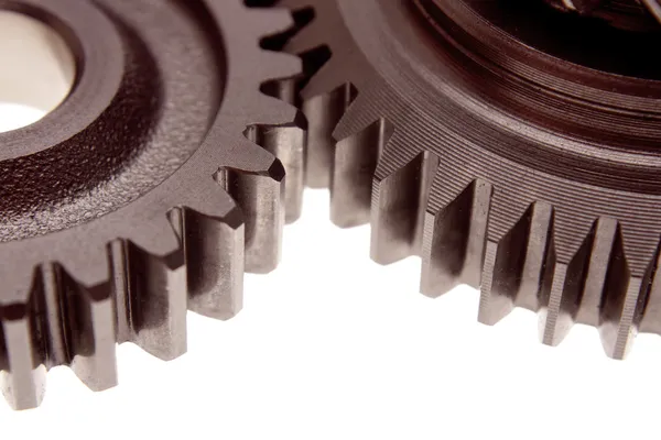 Closeup of two cogs on plain background — Stock Photo, Image