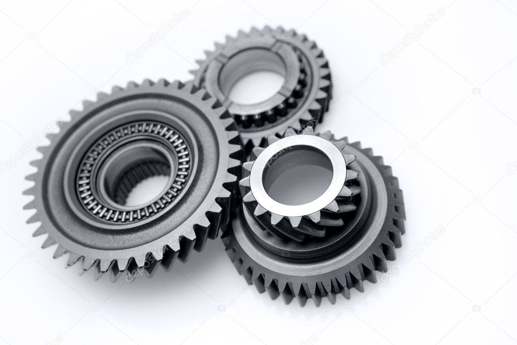 Three metal gears on plain background