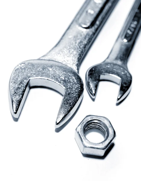 Spanners and nut on plain background — Stock Photo, Image