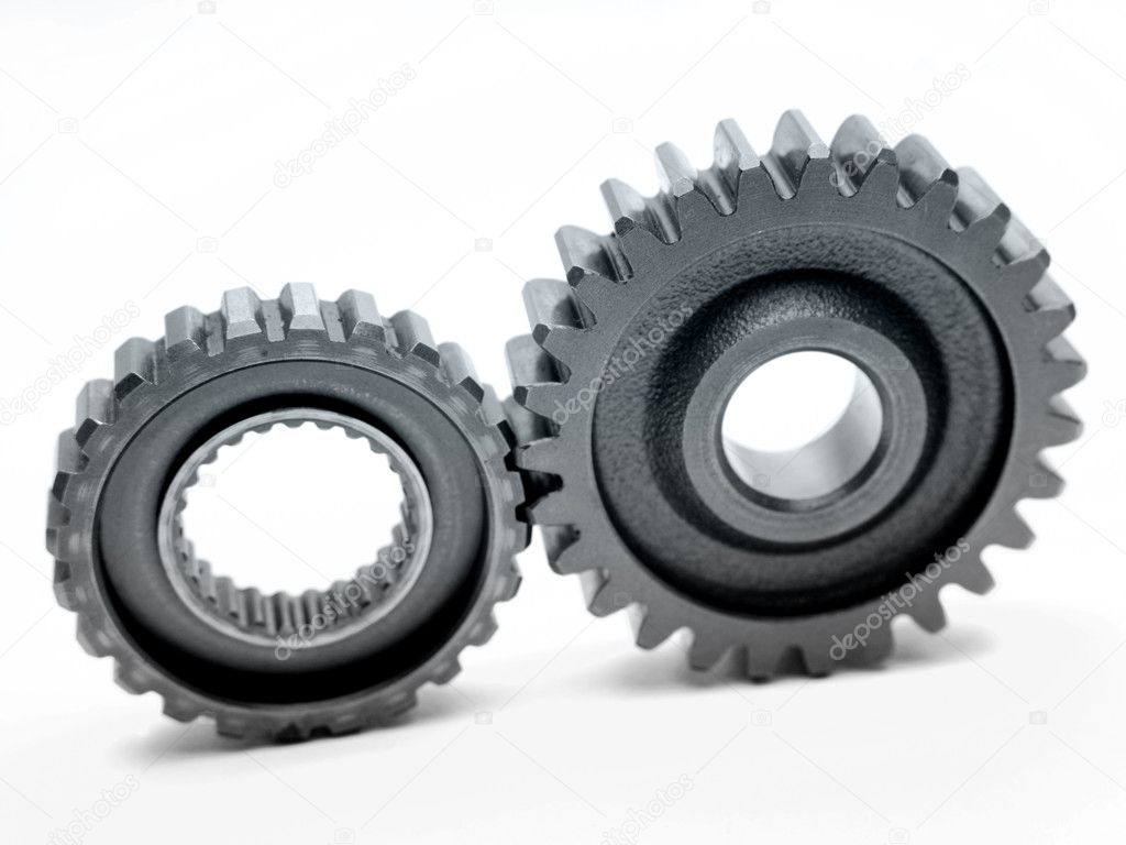 Two cogs connecting over white