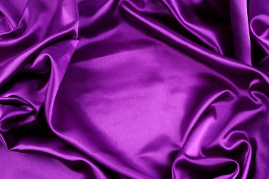 Closeup of folds in purple silk fabric clipart