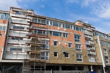 Insulation in new residential building shell clipart