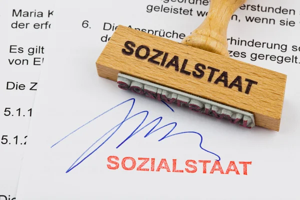 stock image Wood stamp on the document: the welfare state